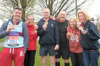 Some of the Farnham Runners with their medals after the 2013 London Marathon