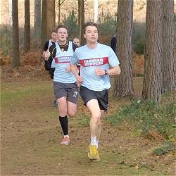 Andrew Ellison and Richard Lovejoy running through Bourne Woods in the 2013 SXCL race at Farnham