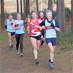 Jane Georghiou and Kayleigh Copeland running through Bourne Woods in the 2013 SXCL race at Farnham