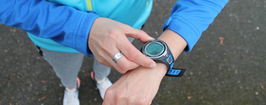 Runner setting sports watch