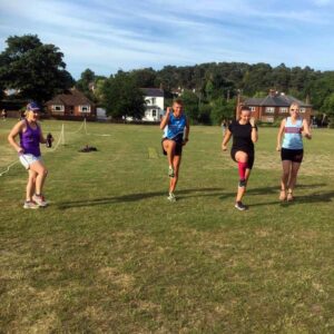 Runners warming up for Covid speed training session at the Bourne Green