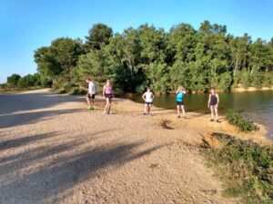 Runners by lake on Covid training run at Caesars Camp