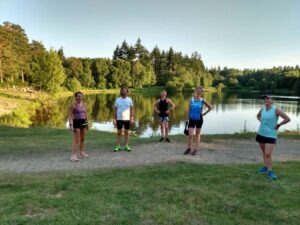 Runners by lake on Covid training run at Caesars Camp