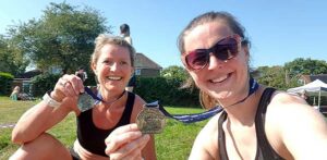 Vicky Goodluck and Helen Bracey with their Pilgrims half marathon medals
