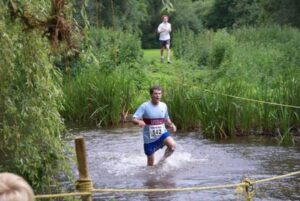 Member running through river at 2008 Elstead Marathon