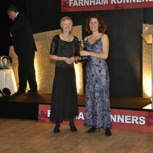 Jane Georghiou presenting Sarah Hill with the marthon trophy at 2012 Annual Awrads Dinner