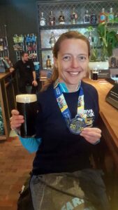 Helen Bracy with pint of Guiness after 2019 Belfast Marathon