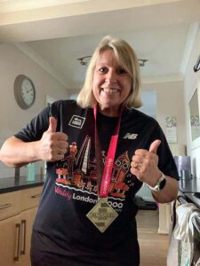 Carolyn Wickham with medal and T shirt after the 2020 Vitality 10km