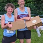 Linda Tylar and Terry Copeland with their 2021 Alresford 10km prizes