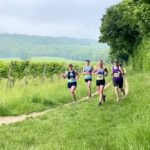 Farnham Runners running through vineyards in the Denbie's Wine Estate during the 2021 North Downs Trail Half Marathon