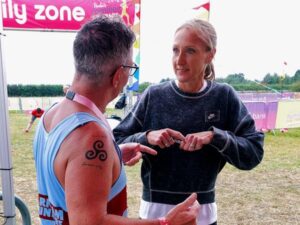 Paul Mackie passes on tips about running to Paula Radcliffe at the 2021 RunFestRun
