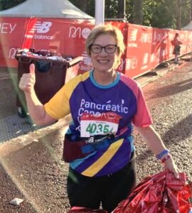 Alison Mungall giving a thumbs up after finishing the 2021 London Marathon