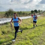 Kay Copeland and Clive Frostick running in the 2021 SXCL Folly Farm race