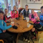 Six of the eight runners that set out enjoying hot drinks after completing their 13 miles training run home from the 2022 SXCL Chawton House