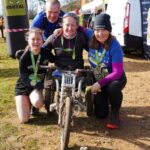 2022 Brutal 5k a proud Rachel Morris in her wheelchair after the race, with Farnham Runners Kate Townsend left and Nicola O'Connor along with Lee Ludlow