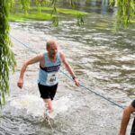 Terry Copeland crosses the River Wey during the 2022 Elstead Marathon