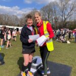 Linda Tyler receives her prize from race director Penny Abbott after the 2022 Fleet Half Marathon