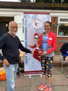 Founder member John de Moraes presents Emma Patton with the overall ladies' trophy at the 2022 Championship