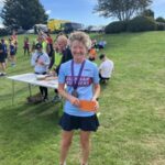 Linda Tyler receiving her prize at the 2022 Solent Half Marathon
