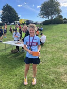 Linda Tyler receiving her prize at the 2022 Solent Half Marathon