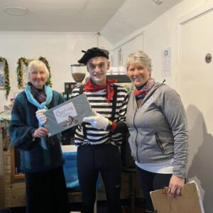 2022 Club Handicap Fancy dress winner Coiln Addison as a mime artist being presented with chocolates