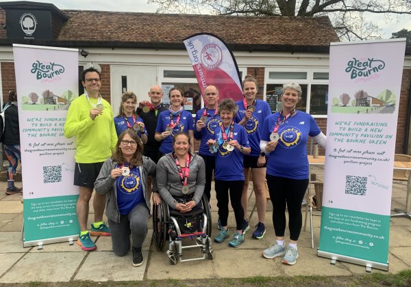 Group of Farnham Runners with their 2023 marathon medals outside the Bourne Club House