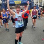 Linda Tyler celebrating after finishing the 2019 Boston Marathon