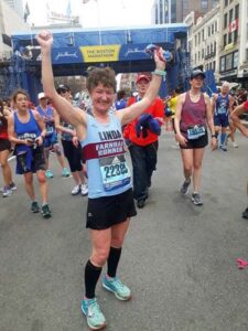 Linda Tyler celebrating after finishing the 2019 Boston Marathon