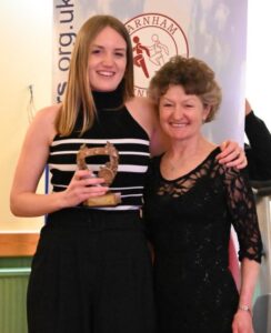 Bella Weetch receives the ladies' most PB award from Linda Tyler at the 2022-23 Farnham Awards Dinner