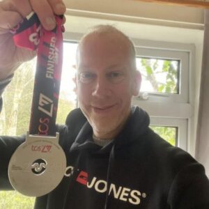 Mark Maxwell at home with his medal after the 2023 London Marathon