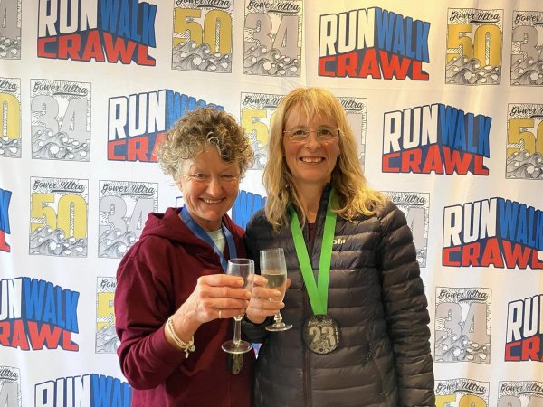 Farnham Runners Linda Tyler and Sue Taylor celebrating after their run in the 2023 Gower Coastal Trail Races