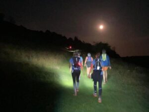 Farnham Runners team running up one of the many hills during the 2023 Midnight Marathon