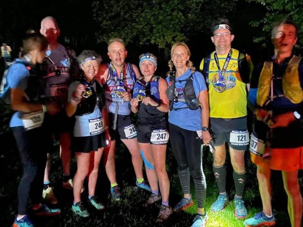 Farnham Runners team with their medals after the 2023 Midnight Marathon