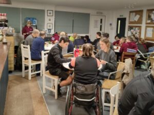 A Farnham Runners club supper and quiz in 2023 with quizmaster Louise Granell asking the questions and others sitting at tables