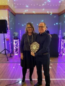 Justin Clarke receiving the Chairman's Award at the Farnham Runners 2023 season awards dinner