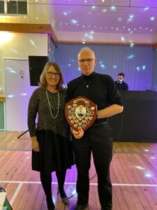 Chris Gill receiving the Steve Parker Award at the Farnham Runners 2023 season awards dinner