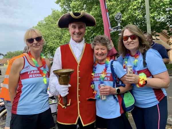 Farnham Runners Sue Taylor, Linda Tyler and Nicola O'Connor at the 2024 Farnham Carnival with the Town Crier