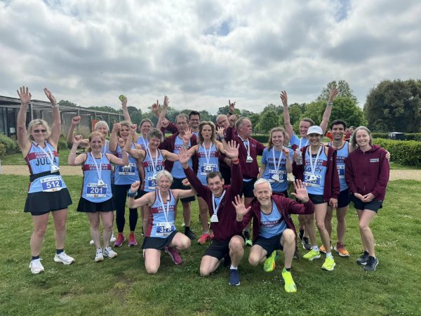 Farnham Runners group waving to celebrate after the 2024 HRRL Netley 10k