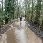 Stephen Buckmaster running through the floods in Dean Lane in Farnham during the 2024-25 Club Handicap race