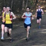 Joe Collins running the the woods at the 2024-25 SXCL Bourne Green cross-country
