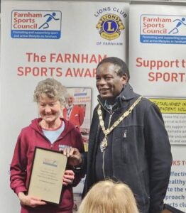 Linda Tyler collecting the award from the Mayor on behalf of the winning Endure 24 Little Dream team at the 2025 Farnham Sports Award