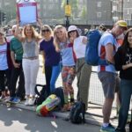 Group of Farnham Runners supporters standing by railings at the side of the course at the 2025 London Marathon