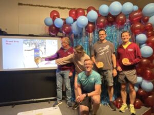 Justin Clarke presenting the men's Grand Prix winners with trophies at the 2025 Farnham Runners AGM and awards evening