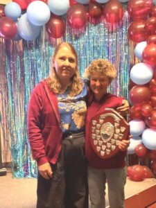 Nicola O'Connor presenting Linda Tyler with the Steve Parker Award at the 2025 Farnham Runners AGM and awards evening