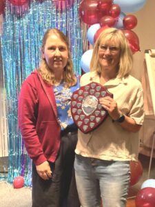 Julia Tagg receiving the Chairman's Award from Nicola O'Connor at the 2025 Farnham Runners AGM and awards evening