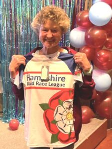 Linda Tyler with her HRRL T-shirt at the 2025 Farnham Runners AGM and awards evening