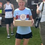 Linda Tyler with her 1st F60 hamper and trophy at the 2025 HRRL Alresford 10k