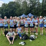 Farnham Runners team posing with the packets of watercress given to participants at the 2025 HRRL Alresford 10k