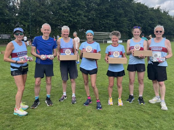 Group of the seven prize winners from Farnham Runners at the 2025 HRRL Alresford 10k (left to right Kay Copeland, Chris Raby, Jane Georghiou, Candy Waller, Linda Tyler, Gabi Hitchcock, Robert Drummond)