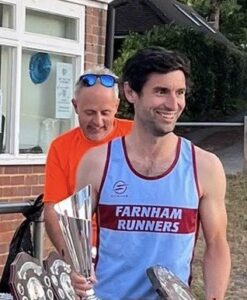 Joe Collins with the senior mens and overall champion trophy and shield at the 2025 Club Championship